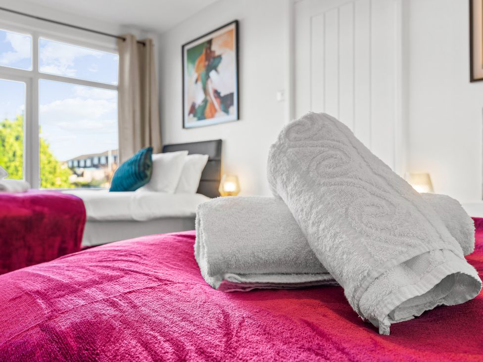 A bedroom with towels on a bed at Edison House Stafford
