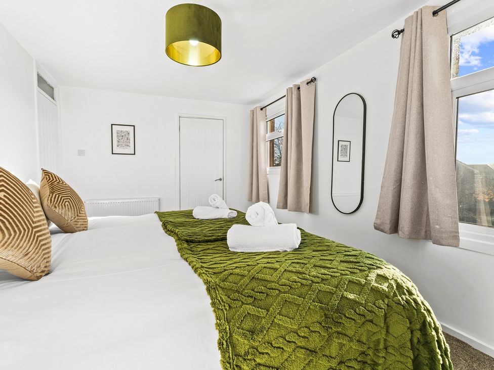 A bedroom with a bed and pillows at Edison House Stafford