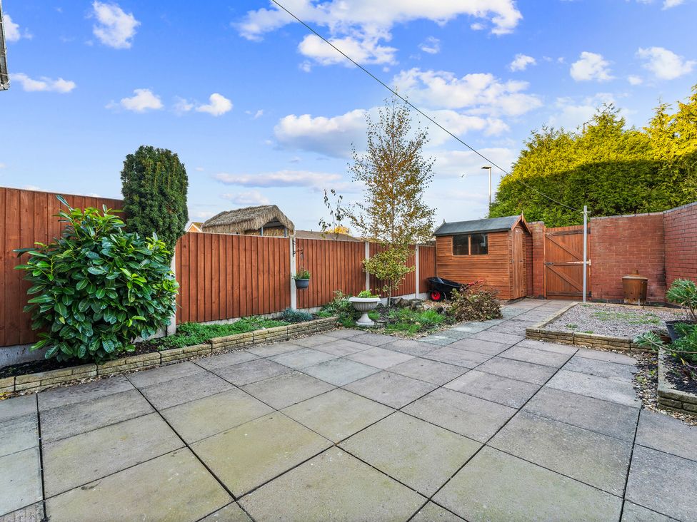 A garden with a patio and a shed at Edison House Stafford