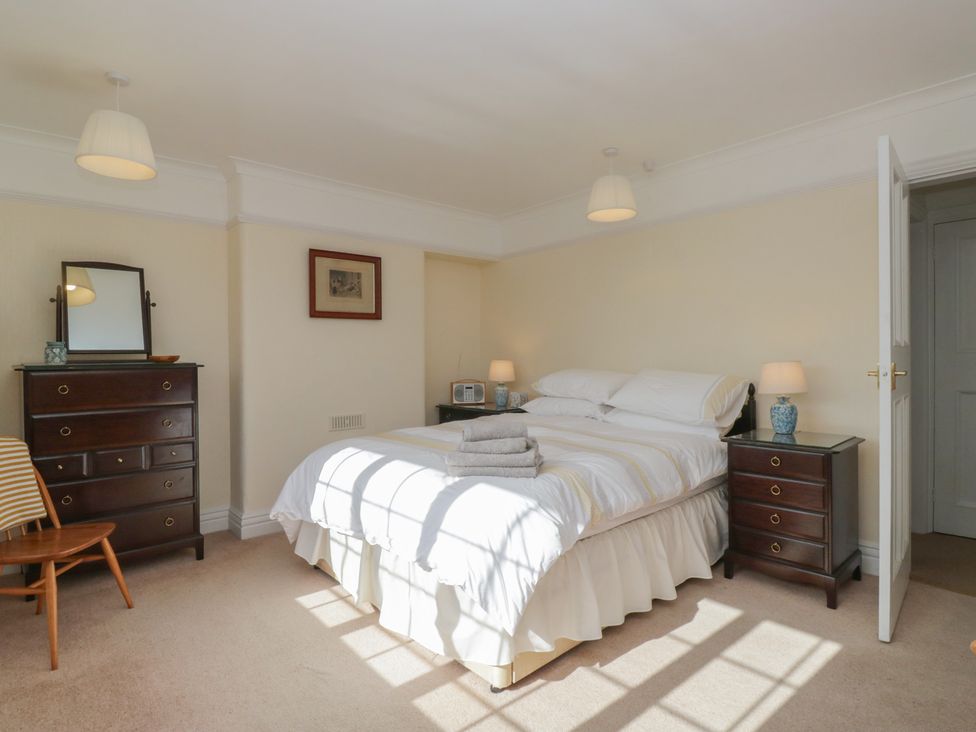 A bedroom with a bed and nightstand at Throstlegarth in Milnthorpe