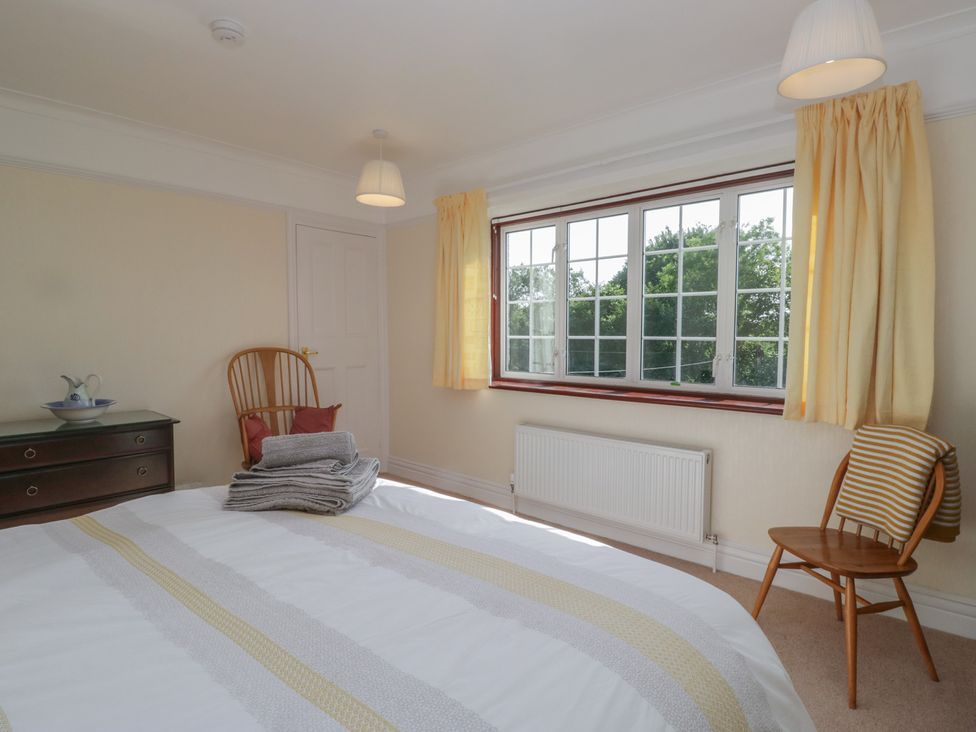 A bedroom with a bed and window at Throstlegarth in Milnthorpe