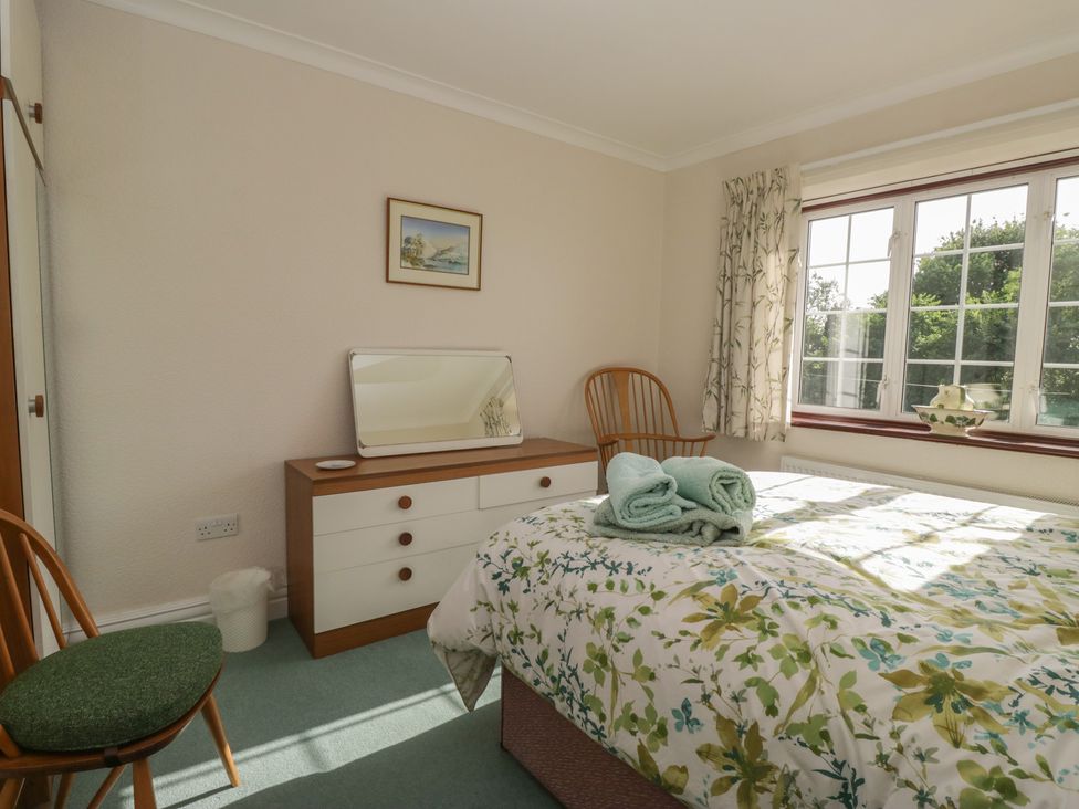 A bedroom with a bed and furniture at Throstlegarth in Milnthorpe