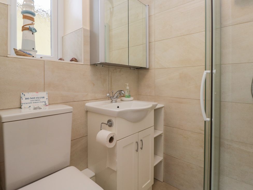 A bathroom with a sink and shower at Throstlegarth in Milnthorpe
