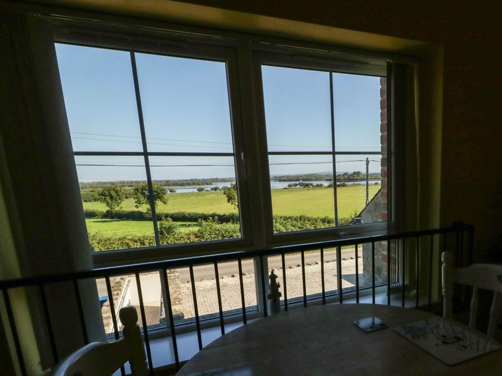A view from a window showing fields and water at The Mummers Studio Apartment 1, Derrylin, County Fermanagh
