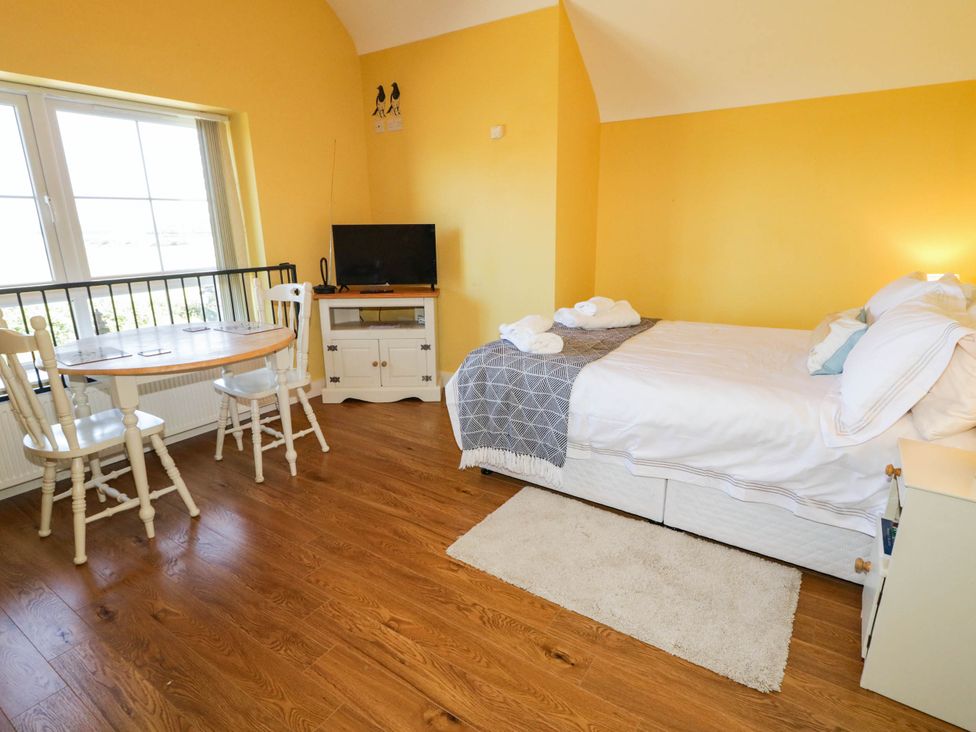 A studio with a bed and dining area at The Mummers Studio Apartment 1, Derrylin, County Fermanagh