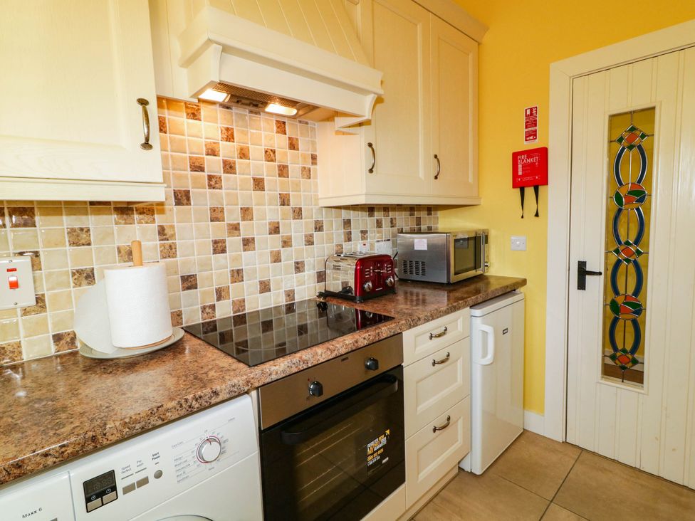 A kitchen with appliances and countertop at The Mummers Studio Apartment 1, Derrylin, County Fermanagh