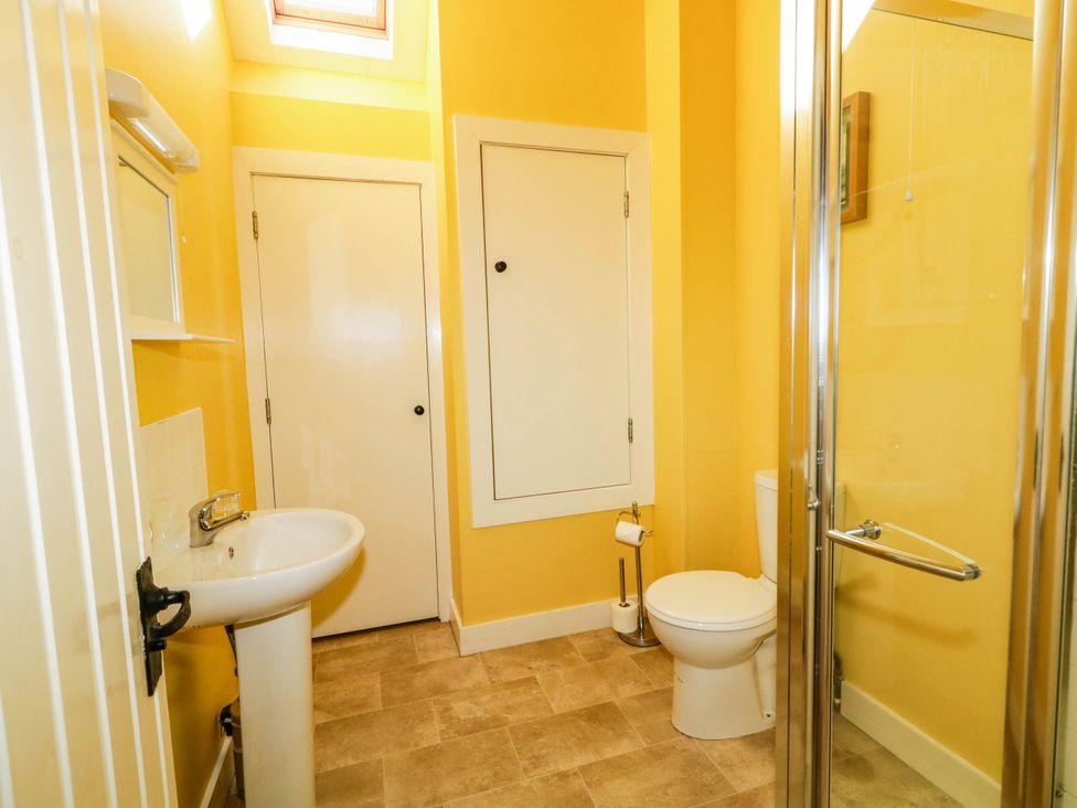 A bathroom with sink, toilet, and shower at The Mummers Studio Apartment 1, Derrylin, County Fermanagh
