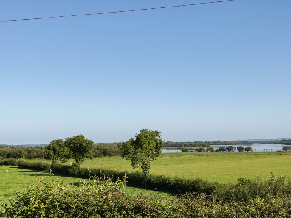 A scenic view of trees and water in a landscape at The Mummers Studio Apartment 1, Derrylin, County Fermanagh