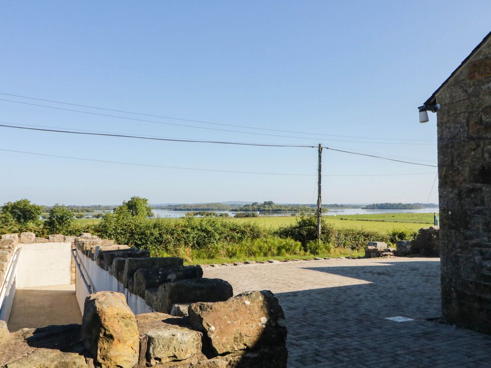 A view of water and greenery from a pathway at The Mummers Studio Apartment 1 in Derrylin, County Fermanagh