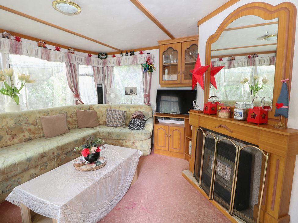 A living room with a sofa and a coffee table at 10 Cater Gardens in Guildford