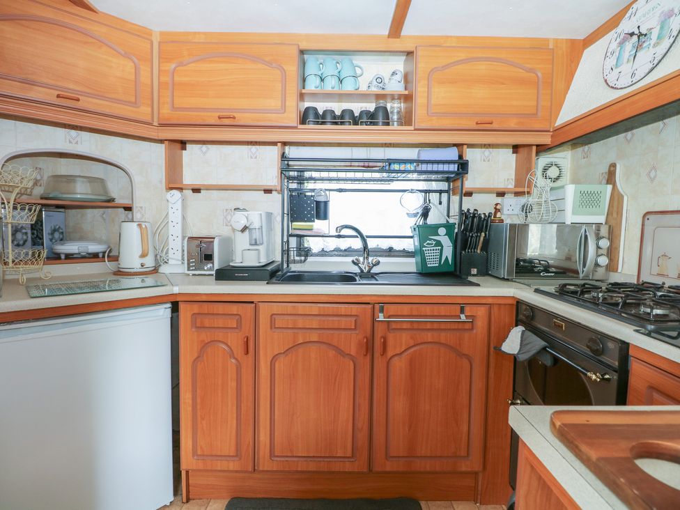 A kitchen with cabinets, sink, and appliances at 10 Cater Gardens, Guildford