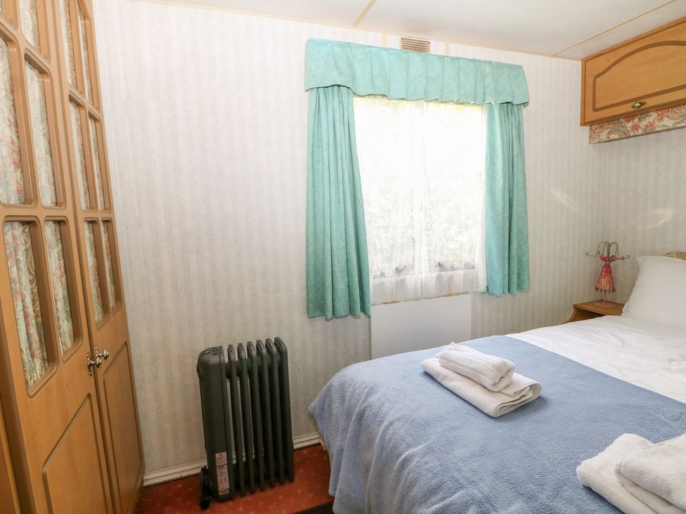 A bedroom with a bed and radiator at 10 Cater Gardens, Guildford
