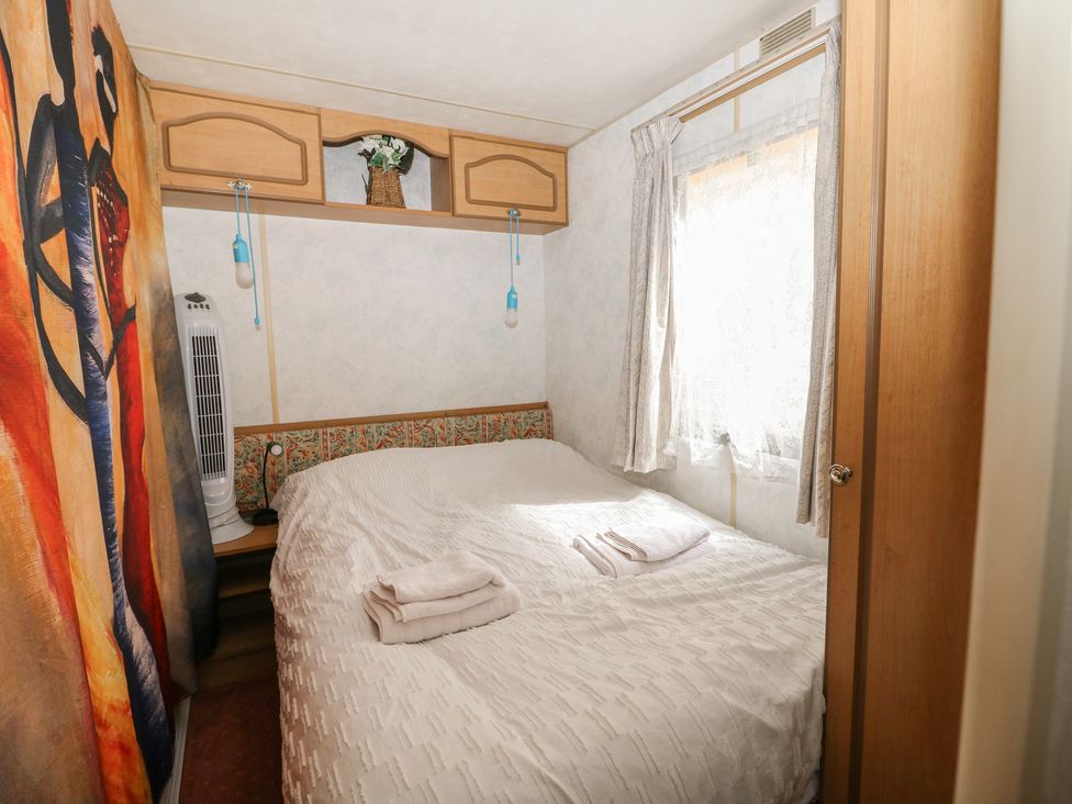 A bedroom with a bed and wall art at 10 Cater Gardens in Guildford