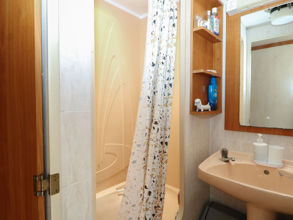 A bathroom with a shower and sink at 10 Cater Gardens in Guildford