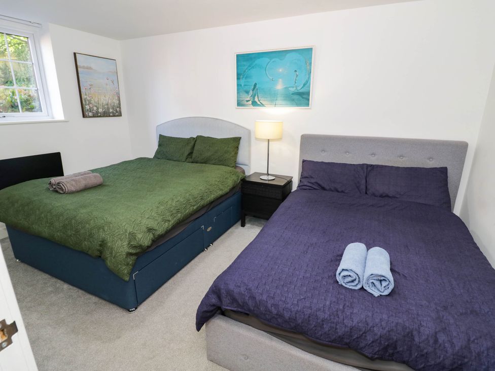 A bedroom with two beds and a nightstand at 1 Pump House, Smethwick