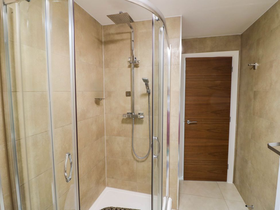 A shower with glass doors in a bathroom at 1 Pump House in Smethwick