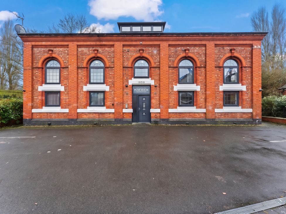 An exterior view of a brick building with windows and a door at 1 Pump House Birmingham