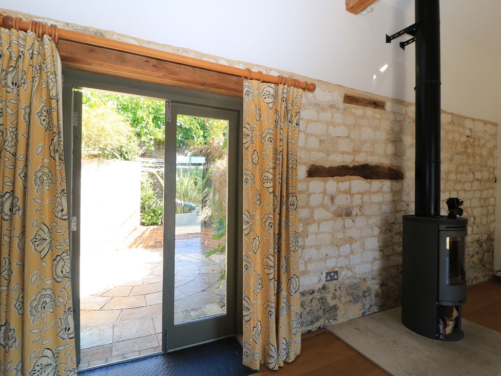 A living room with a door and curtains at Frome Gazey in Frampton