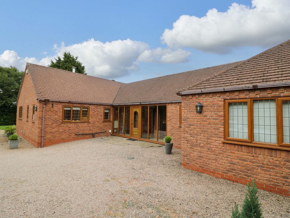 A bungalow exterior with a pathway and plants at Meadow View Bungalow in Droitwich