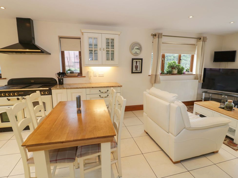 A kitchen with dining table and chairs at Meadow View Bungalow in Droitwich