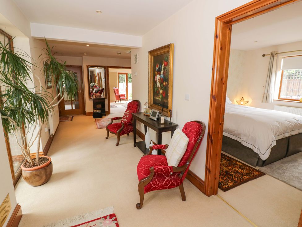 A hallway with chairs and a table at Meadow View Bungalow Droitwich