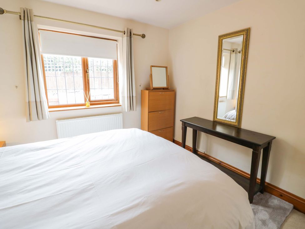 A bedroom with a bed and a dresser at Meadow View Bungalow in Droitwich
