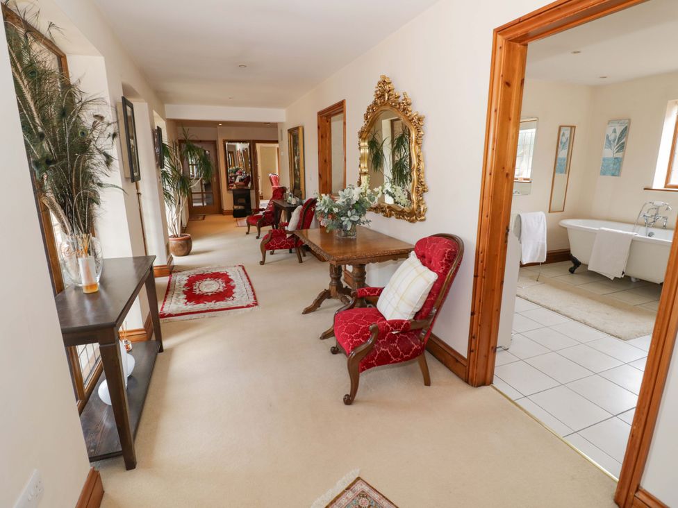A hallway with chairs and a table at Meadow View Bungalow in Droitwich