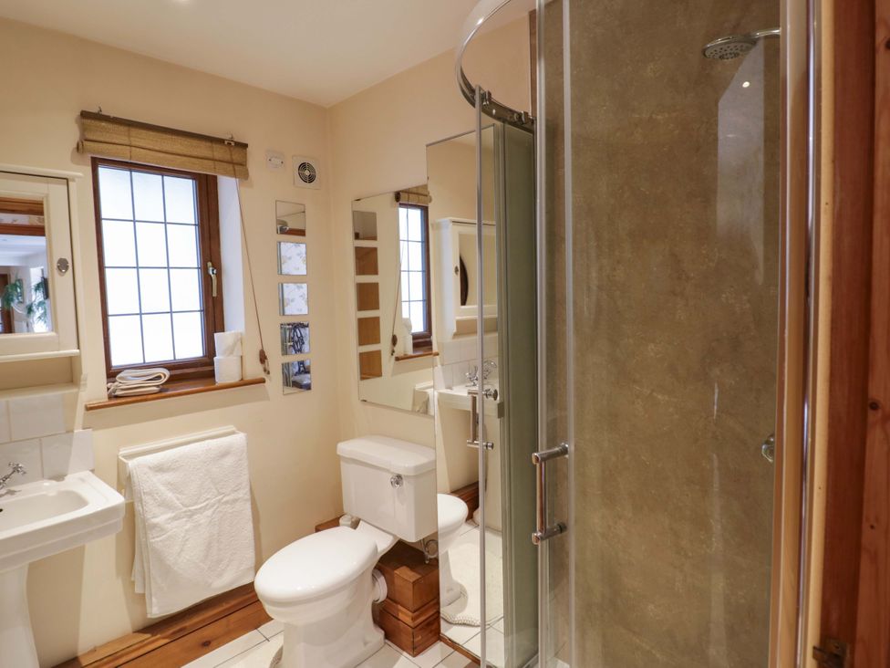 A bathroom with a shower and sink at Meadow View Bungalow in Droitwich