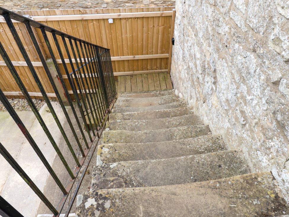 A staircase leading down with a railing at Granary in peterculter