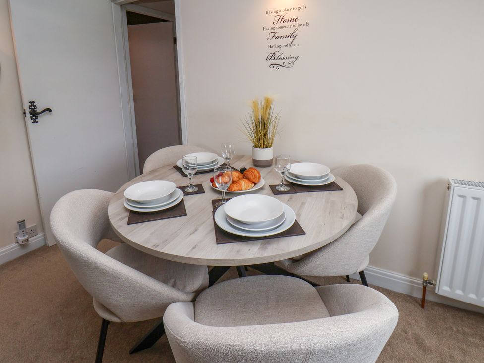 A dining room with a round table and chairs at Granary in peterculter