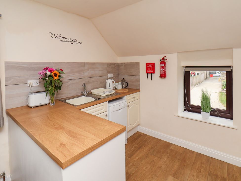 A kitchen with sink and appliances at Granary in peterculter
