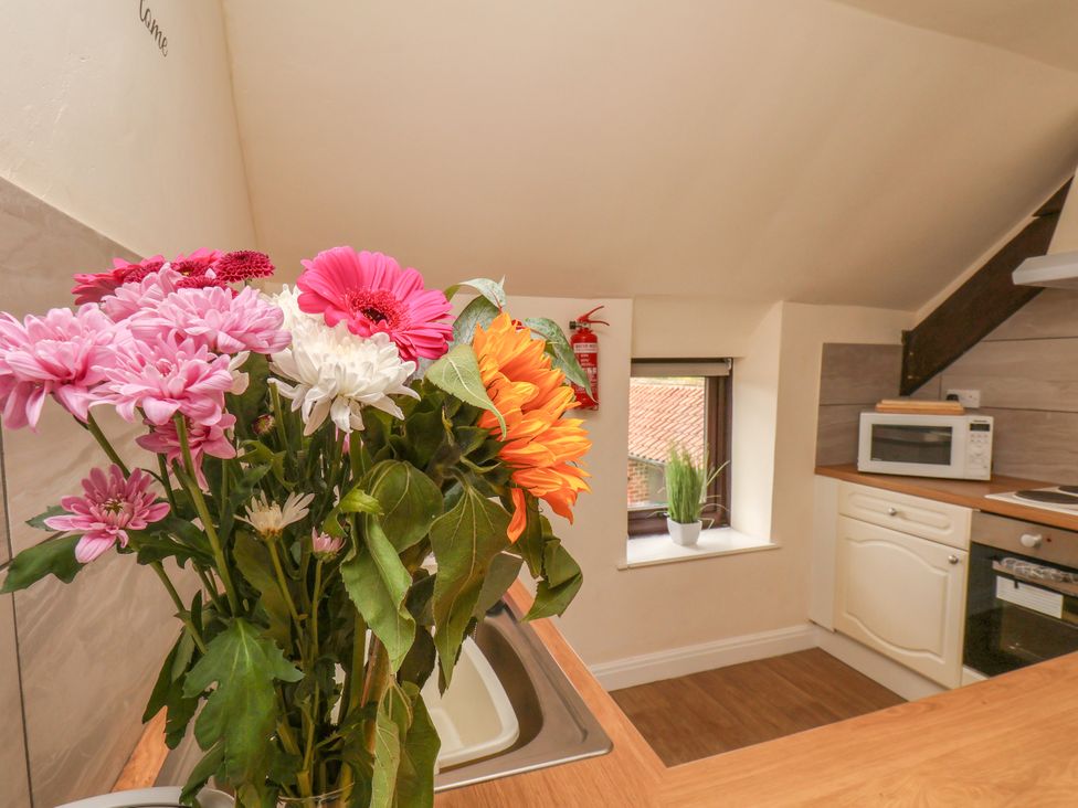 A kitchen with a sink and a bouquet of flowers at Granary in peterculter