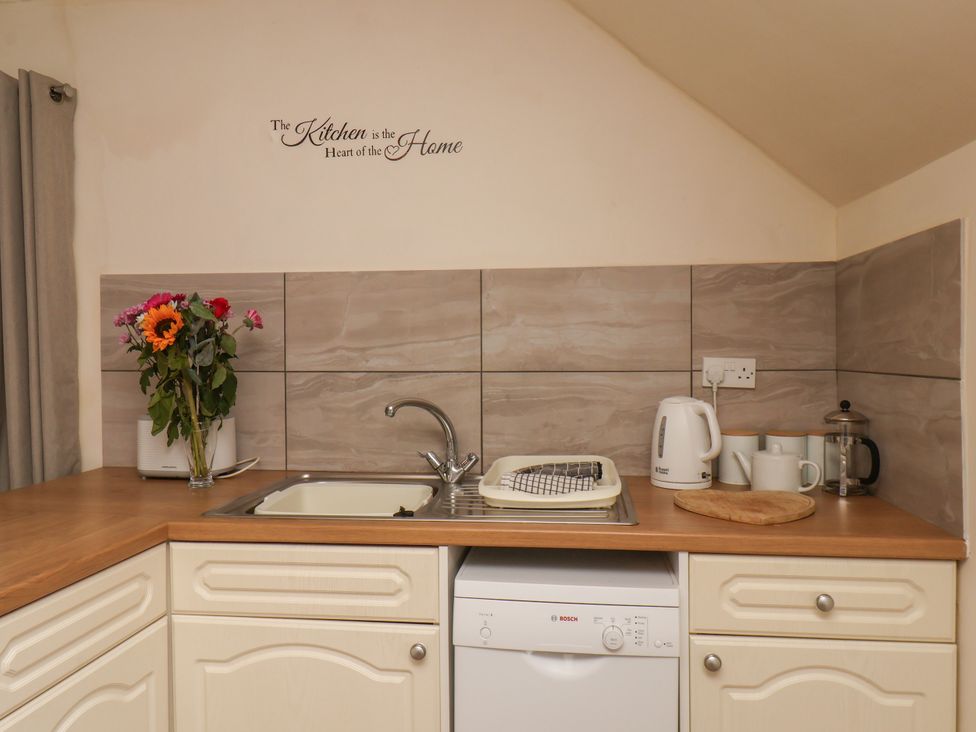 A kitchen with a sink and appliances at Granary in peterculter