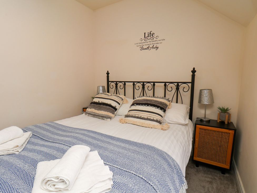 A bedroom with a bed and nightstand at Granary in peterculter