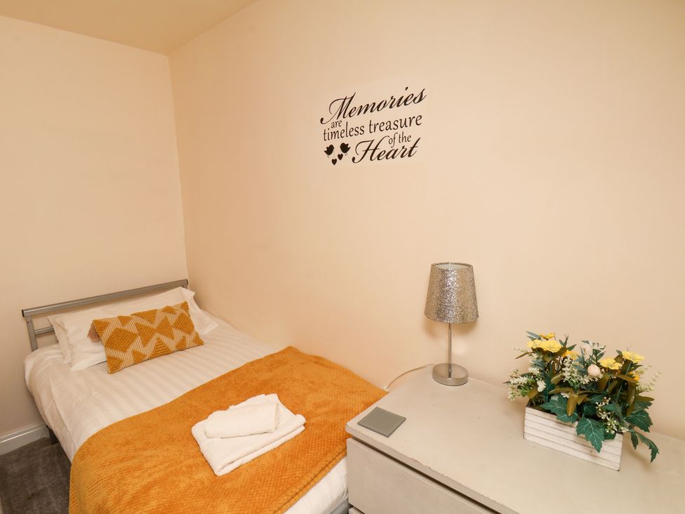 A bedroom with a bed and nightstand at Granary in peterculter