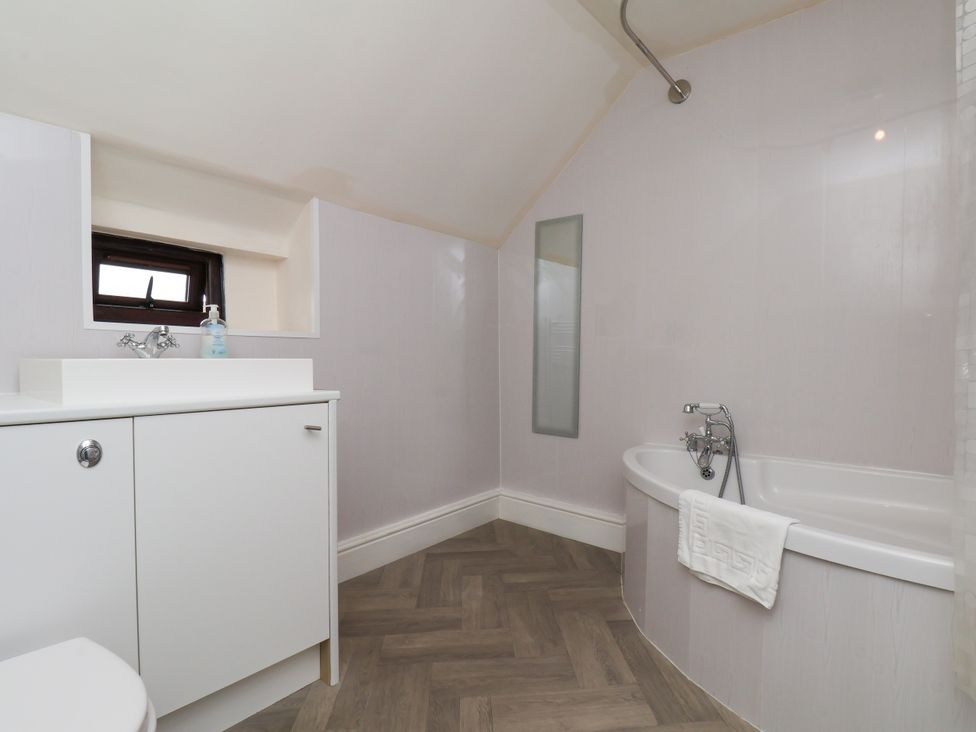 A bathroom with a tub and sink at Granary in peterculter