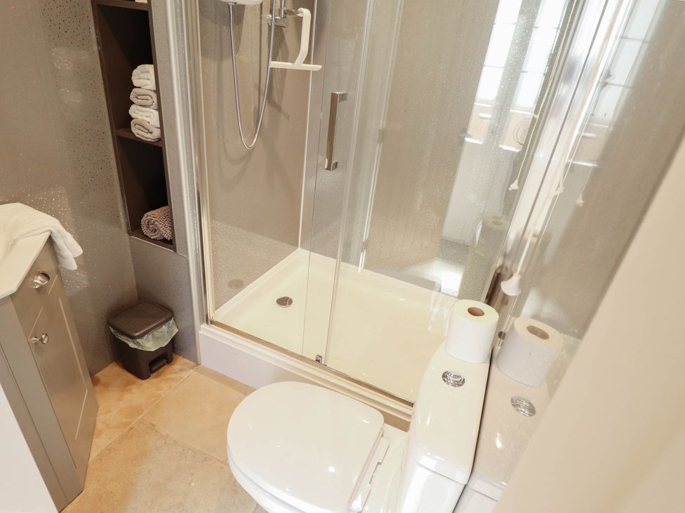 A bathroom with a shower and toilet at Bee Hive Hut in Middleton, Norfolk