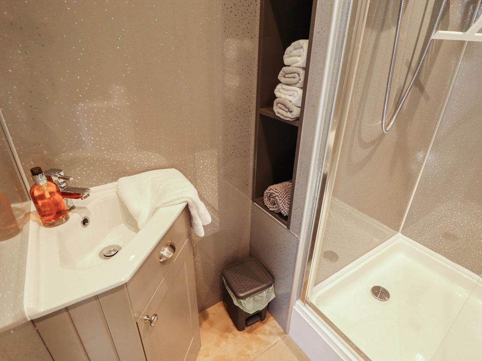 A bathroom with a sink and shower at Bee Hive Hut Middleton, Norfolk