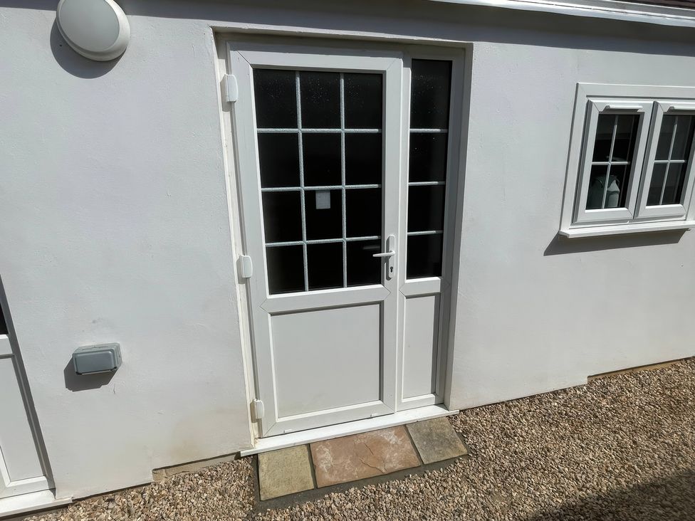 An exterior door with windows beside at Bee Hive Hut Middleton, Norfolk