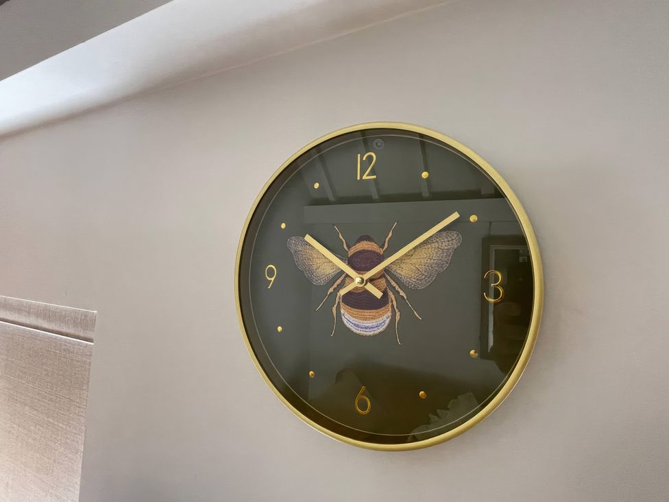 A wall clock with a bee design at Bee Hive Hut, Middleton, Norfolk