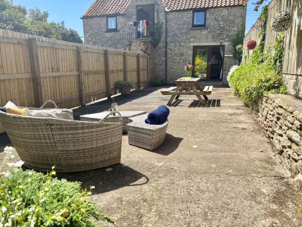 An outdoor space with seating and a table at Owl in Pickering