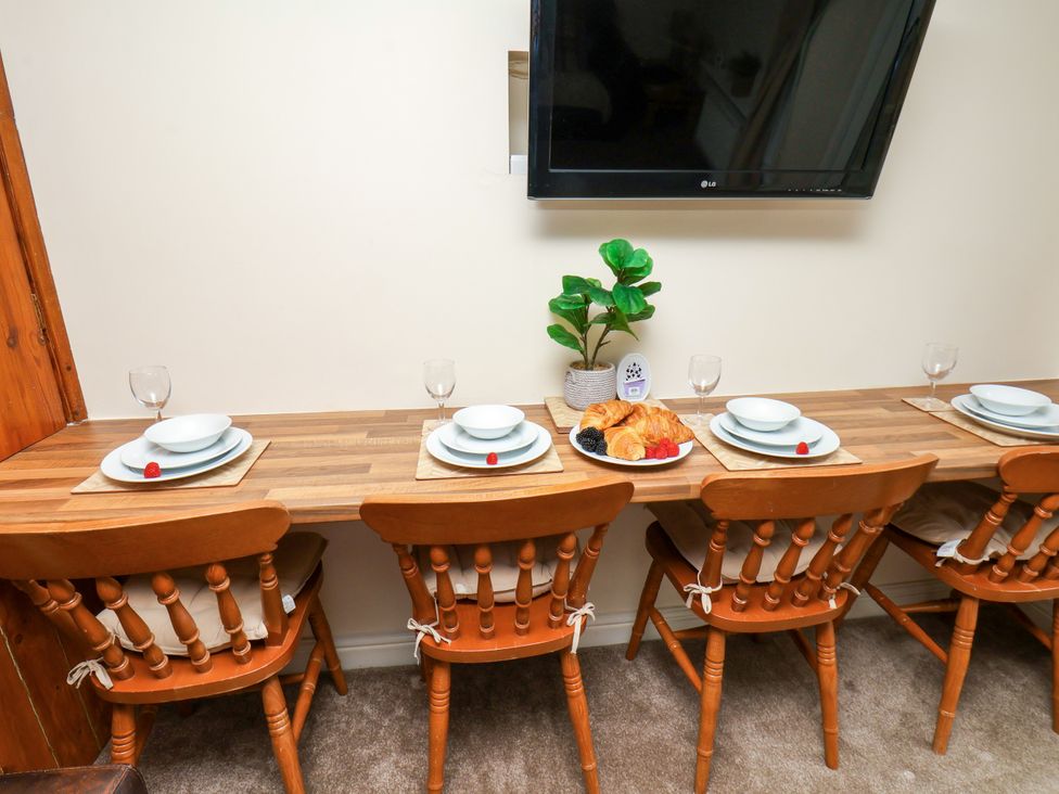 A dining room with a table set for four at Owl in Pickering