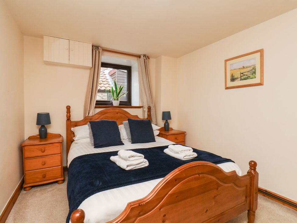 A bedroom with a bed and nightstands at Owl in Pickering