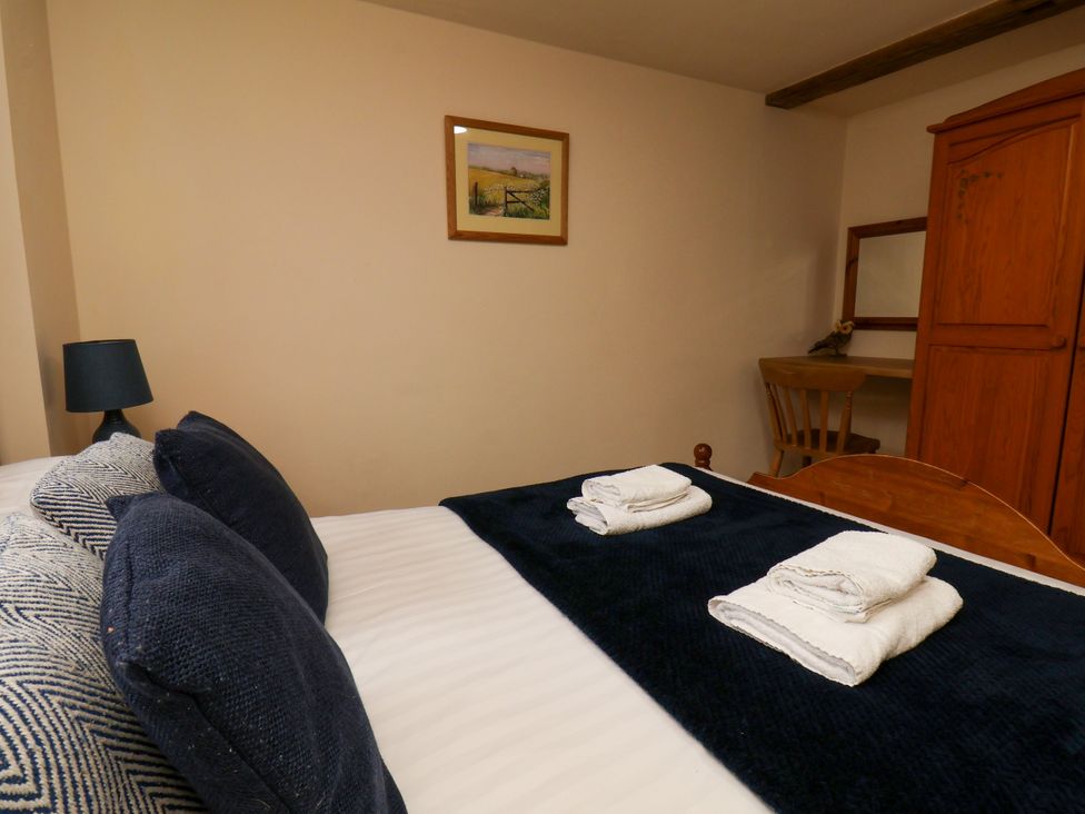 A bedroom with a bed and towels at Owl in Pickering