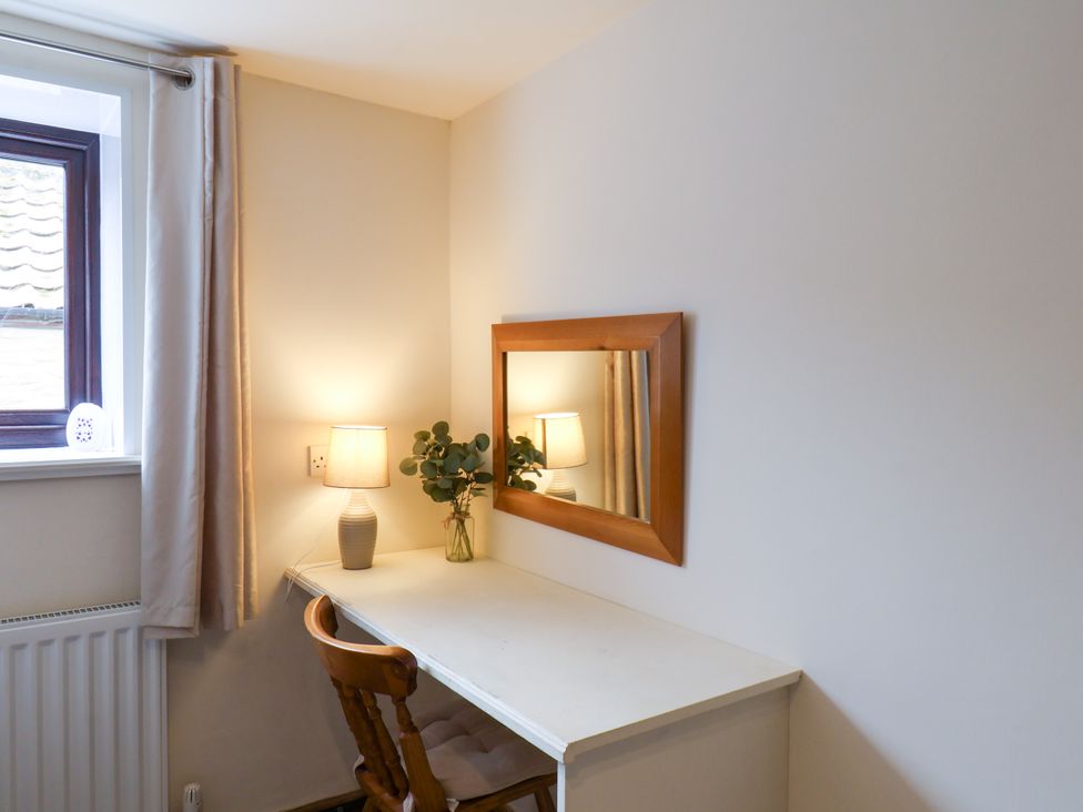 A home office with a desk and lamp at Owl in Pickering
