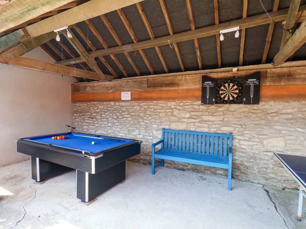 A games room with a pool table and a dartboard at Owl in Pickering