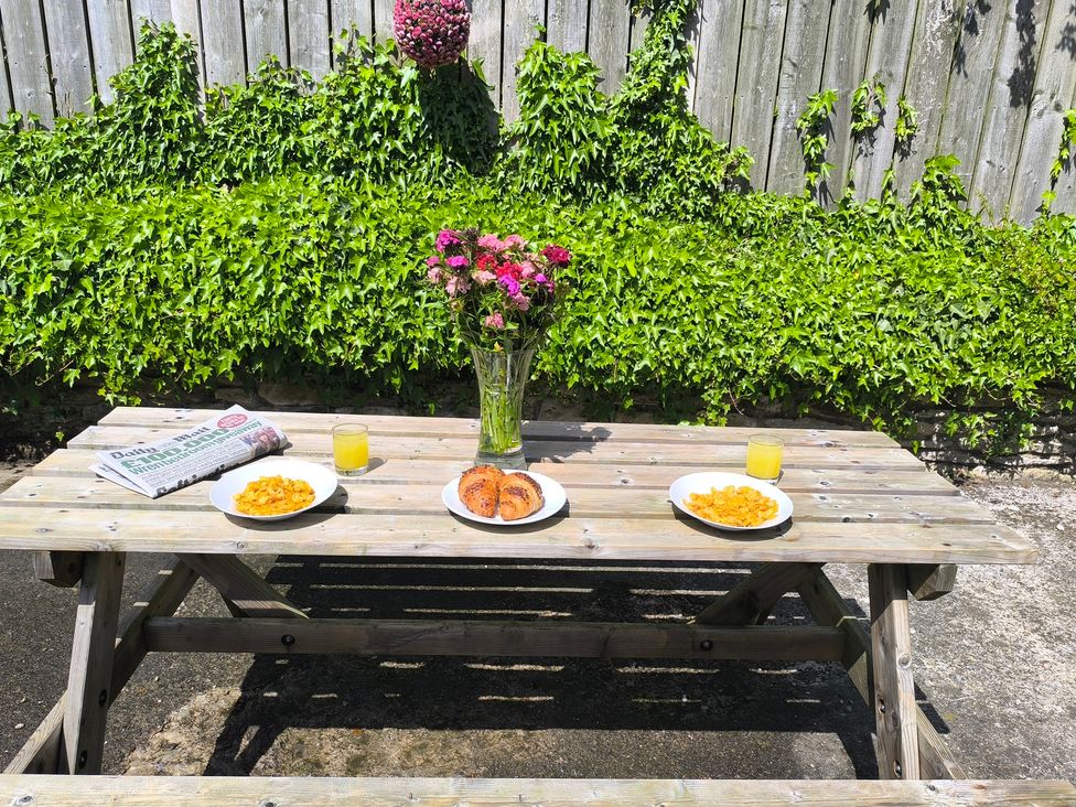 An outdoor dining area with a table set for breakfast at Owl in Pickering