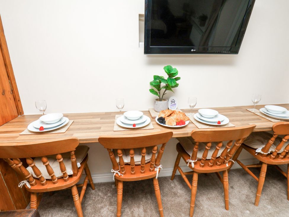 A dining room with a table and chairs at Owl in Pickering