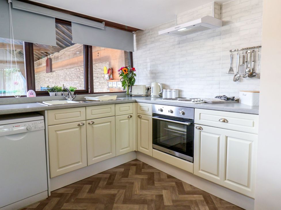 A kitchen with cabinets and oven at Owl in Pickering