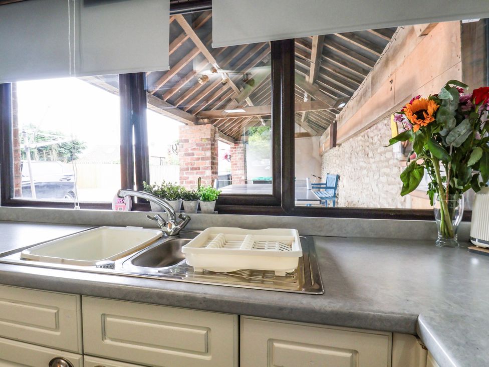 A kitchen with a sink and flower vase at Owl in Pickering